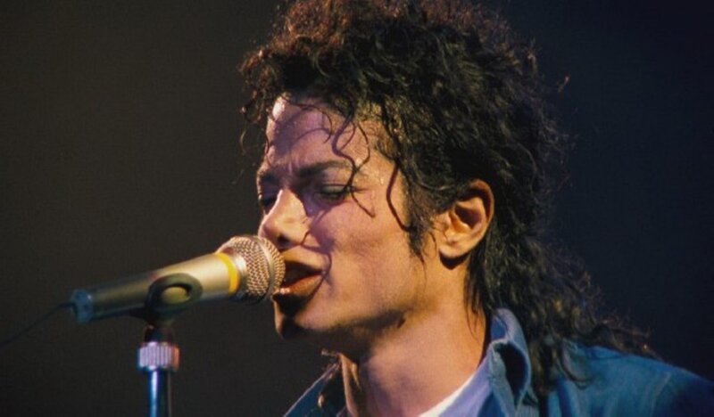 Man Singing into Microphone — Black, Focused