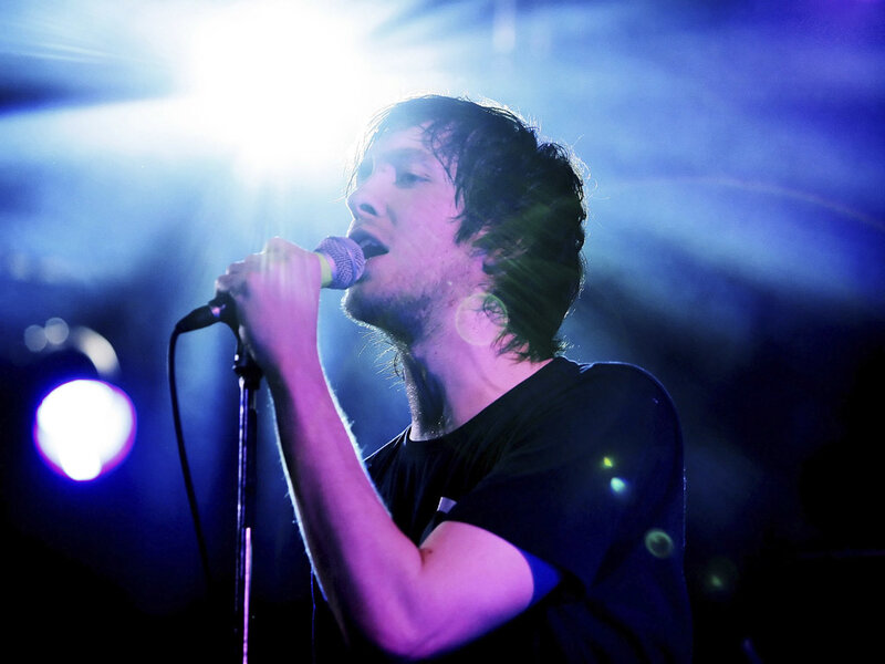 Man Singing into Microphone — Blue, Dramatic, Night, Photograph, Stage Lights, Dark Background