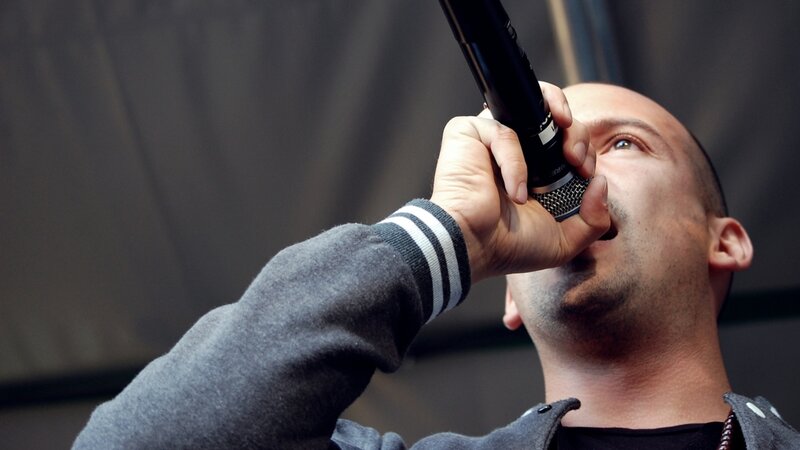 Man Singing into Microphone — Gray