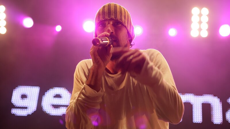 Man Singing into Microphone — Purple, Energetic, Night