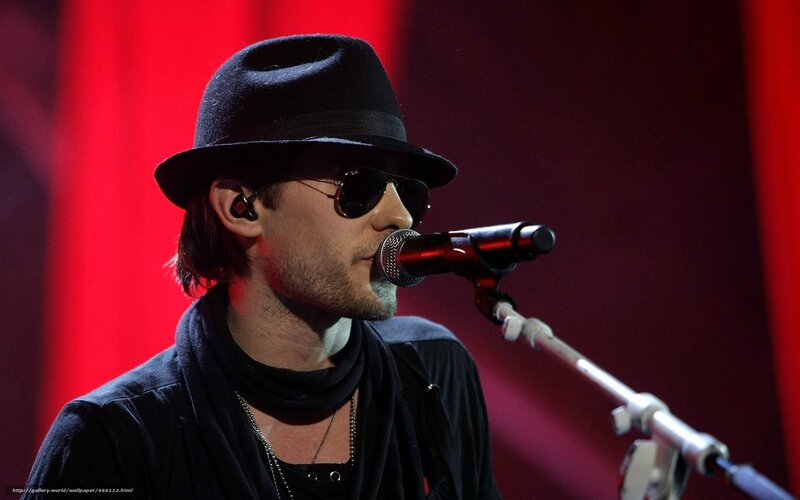 Man Singing into Microphone — Red, Dramatic, Photograph, Hat, Sunglasses