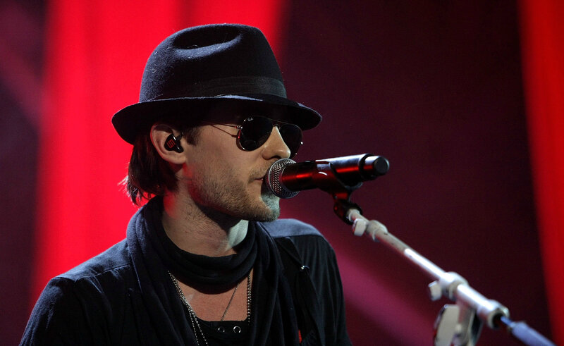 Man Singing into Microphone — Red, Dramatic, Photograph, Hat