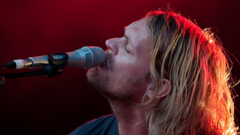 Man Singing into Microphone — Red, Dramatic, Photograph