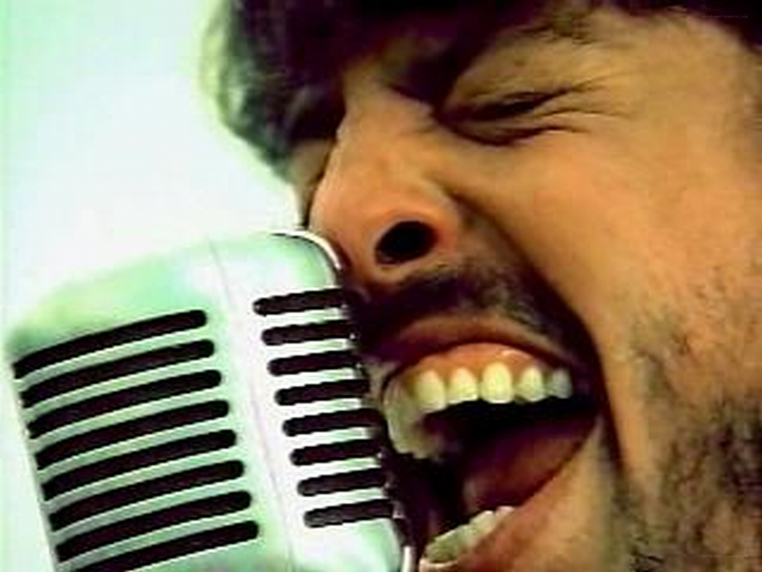 man singing into vintage microphone