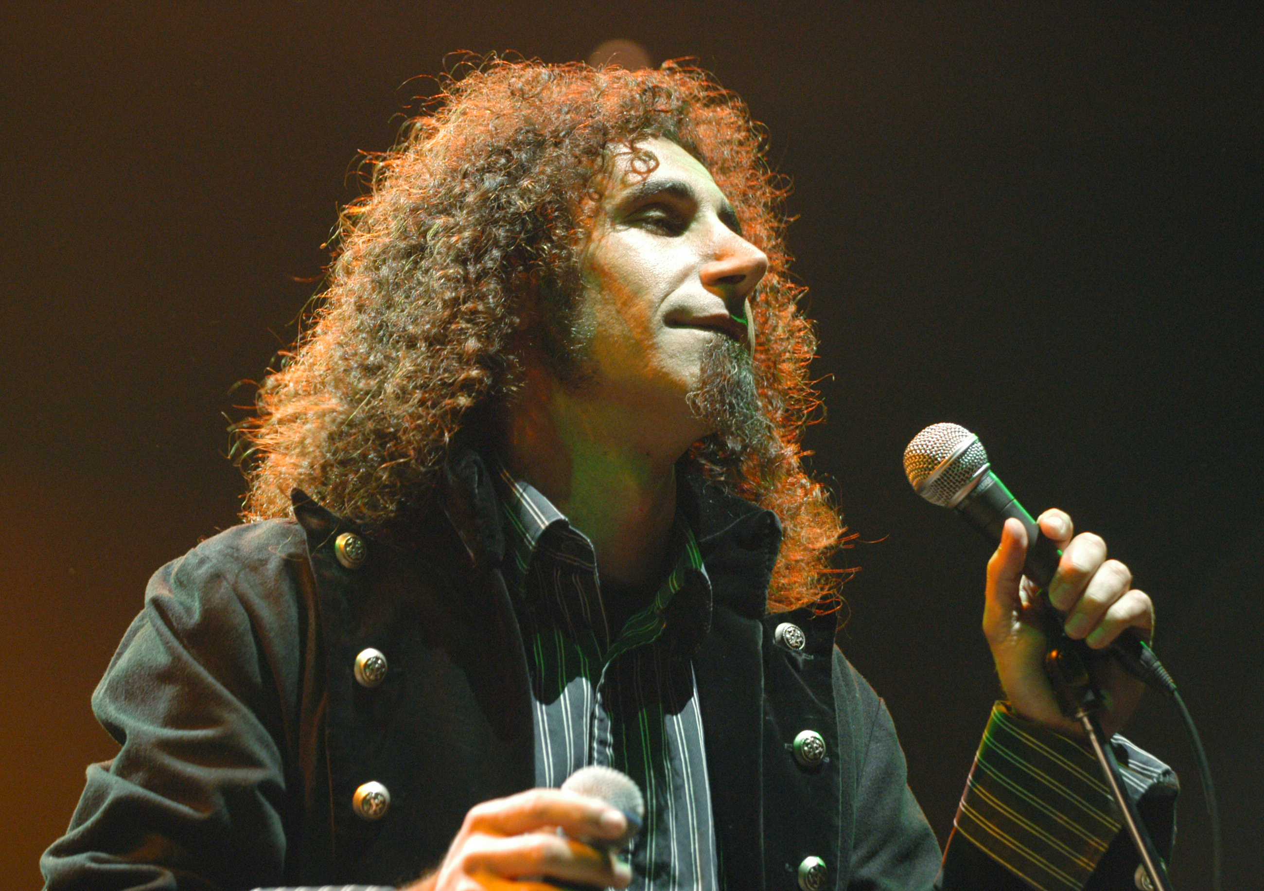 man singing on stage