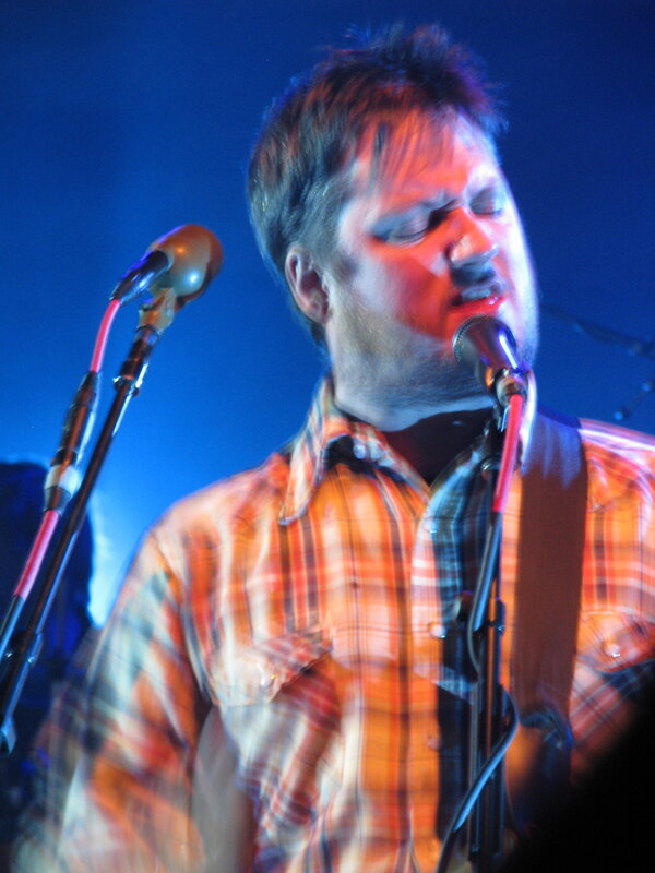 man singing on stage