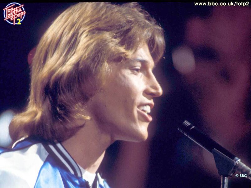 man singing on stage