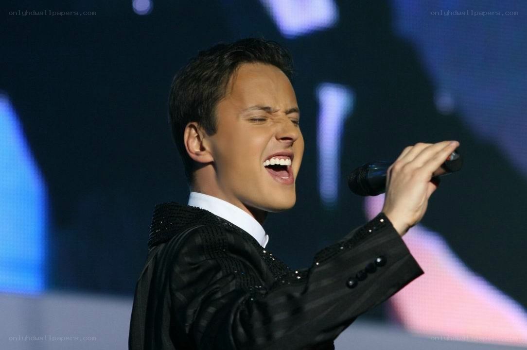 man singing on stage