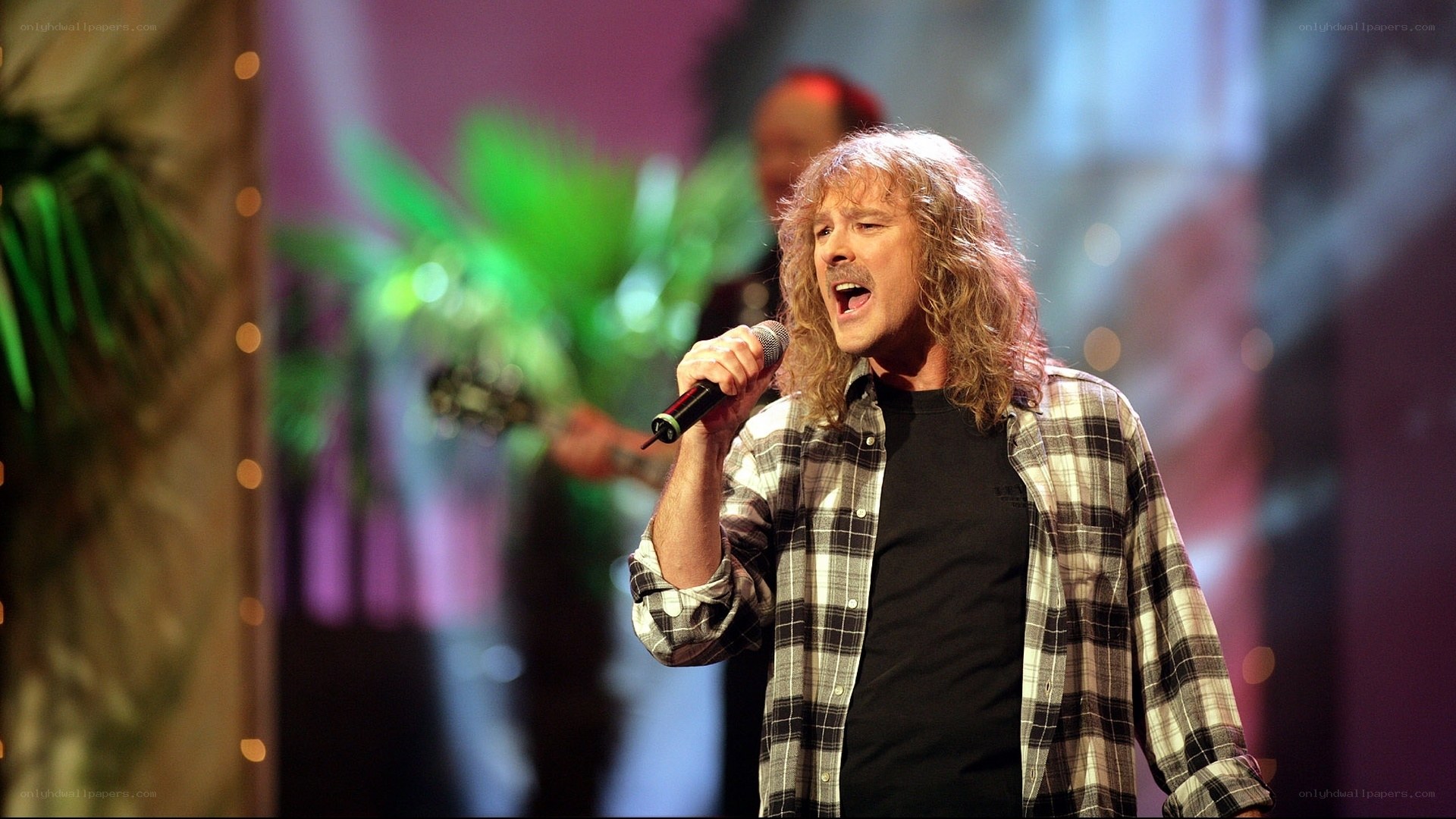 man singing on stage