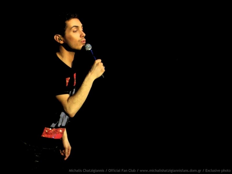 man singing on stage