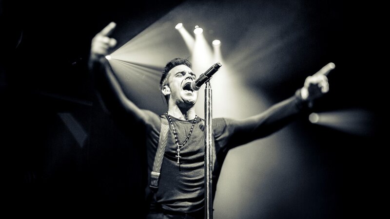 Man Singing on Stage — Black, Dramatic, Night, Photograph, Microphone, Spotlight