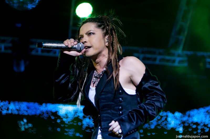 Man Singing on Stage — Black, Energetic, Night, Photograph, Microphone