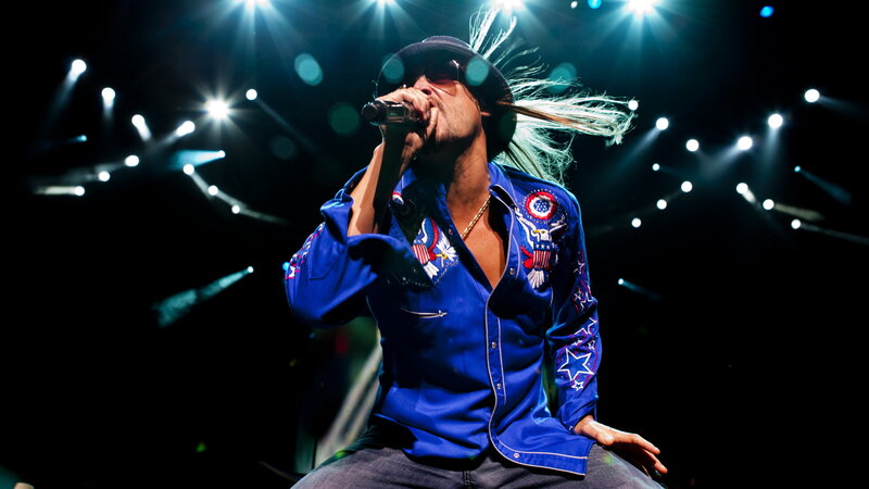 Man Singing on Stage — Blue, Dramatic, Night, Photograph, Microphone, Hat