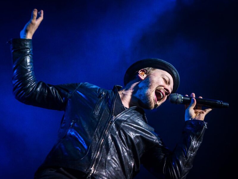 Man Singing on Stage — Blue, Dramatic, Night, Photograph, Microphone, Leather Jacket