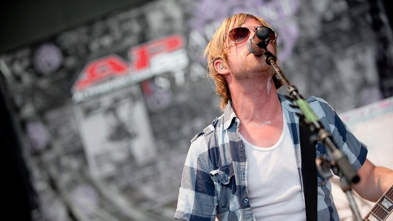 Man Singing on Stage — Blue, Energetic, Afternoon