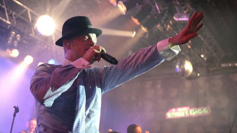Man Singing on Stage — Purple, Energetic, Night