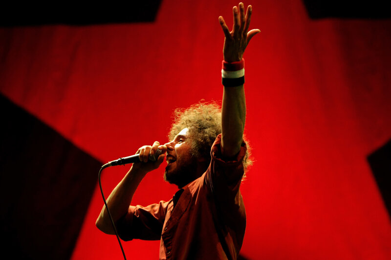 Man Singing on Stage — Red, Dramatic