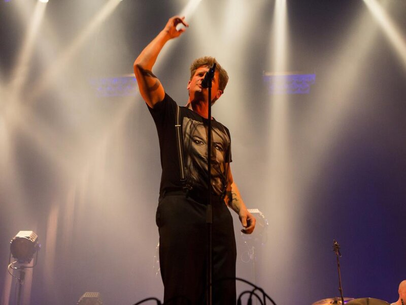 Man Singing on Stage — White, Dramatic, Photograph