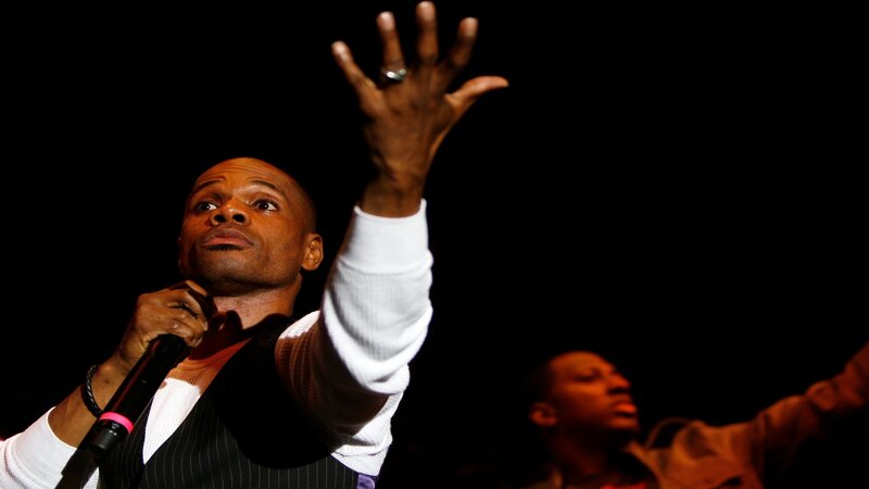 Man singing on stage with microphone