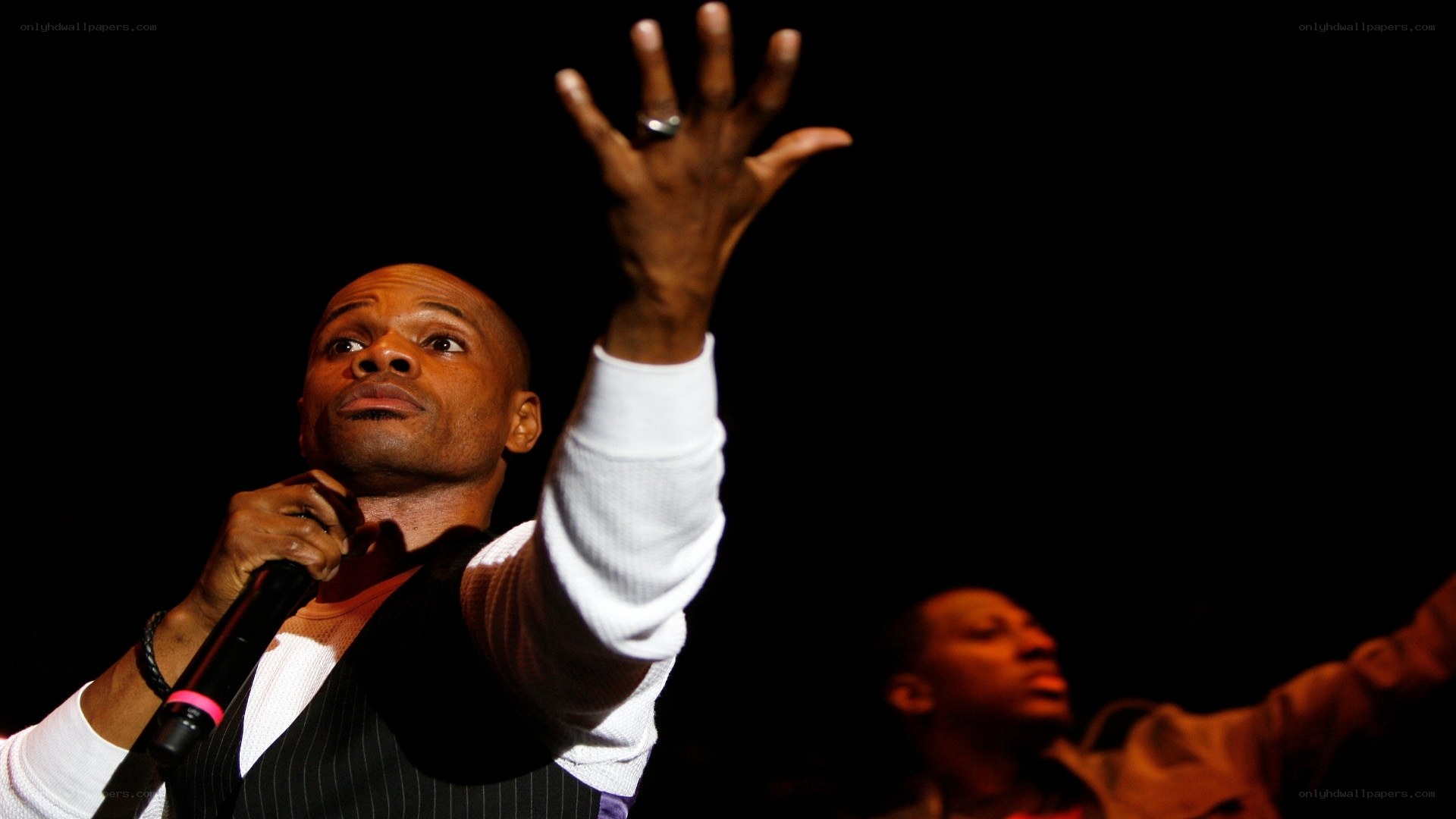 Man singing on stage with microphone