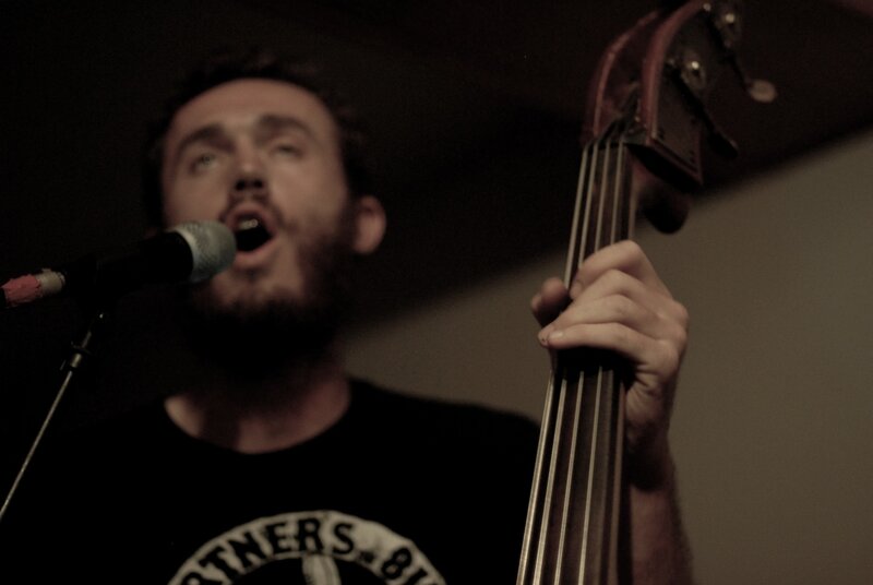 man singing with bass guitar