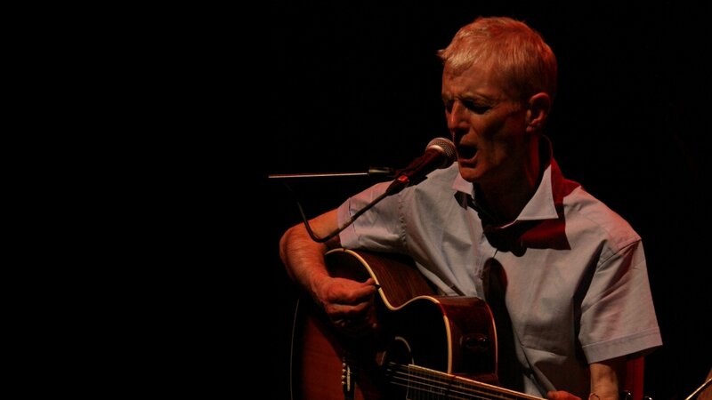 man singing with guitar