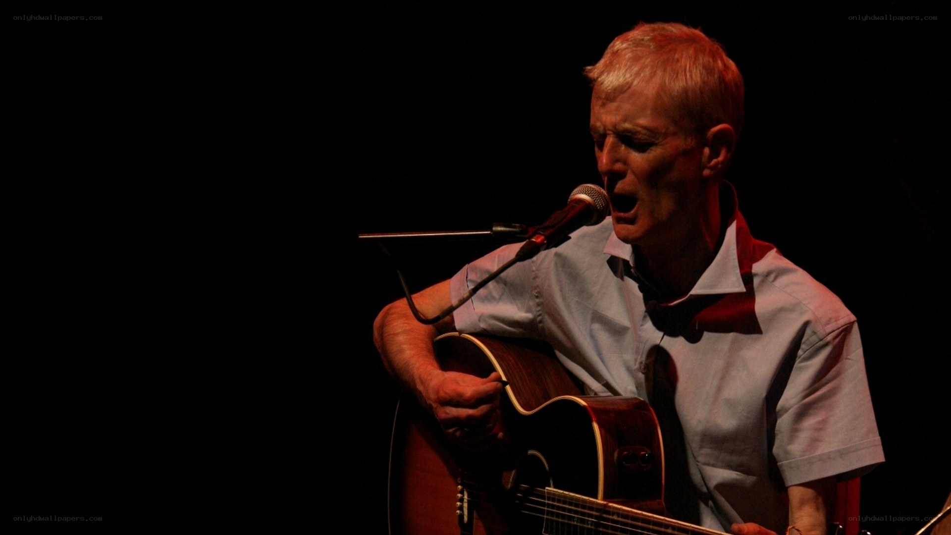 man singing with guitar