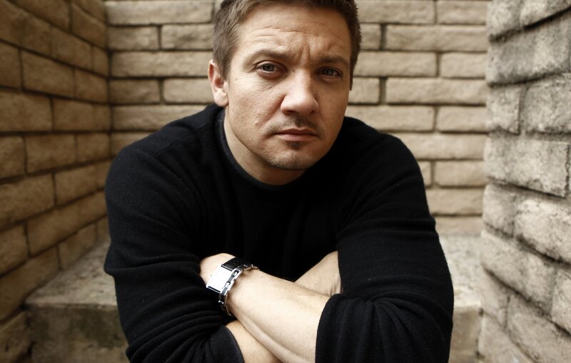 Man Sitting Against Brick Wall — Black