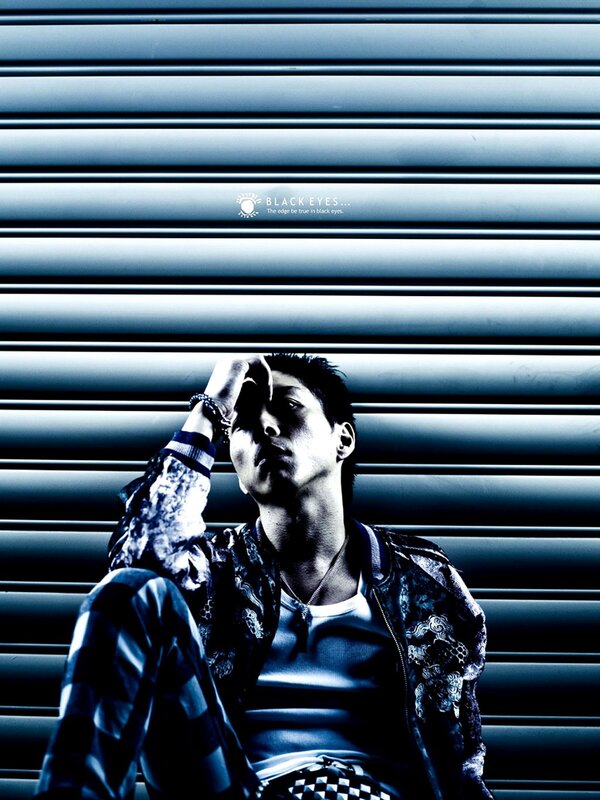 Man Sitting Against Shutter