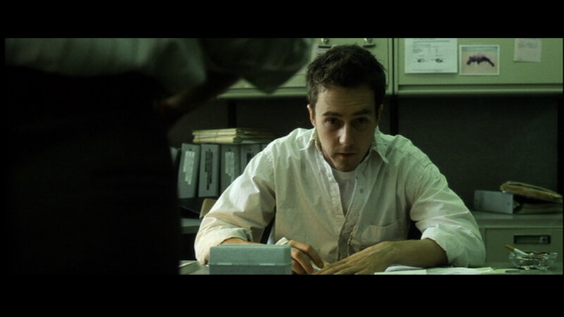 man sitting at desk in office
