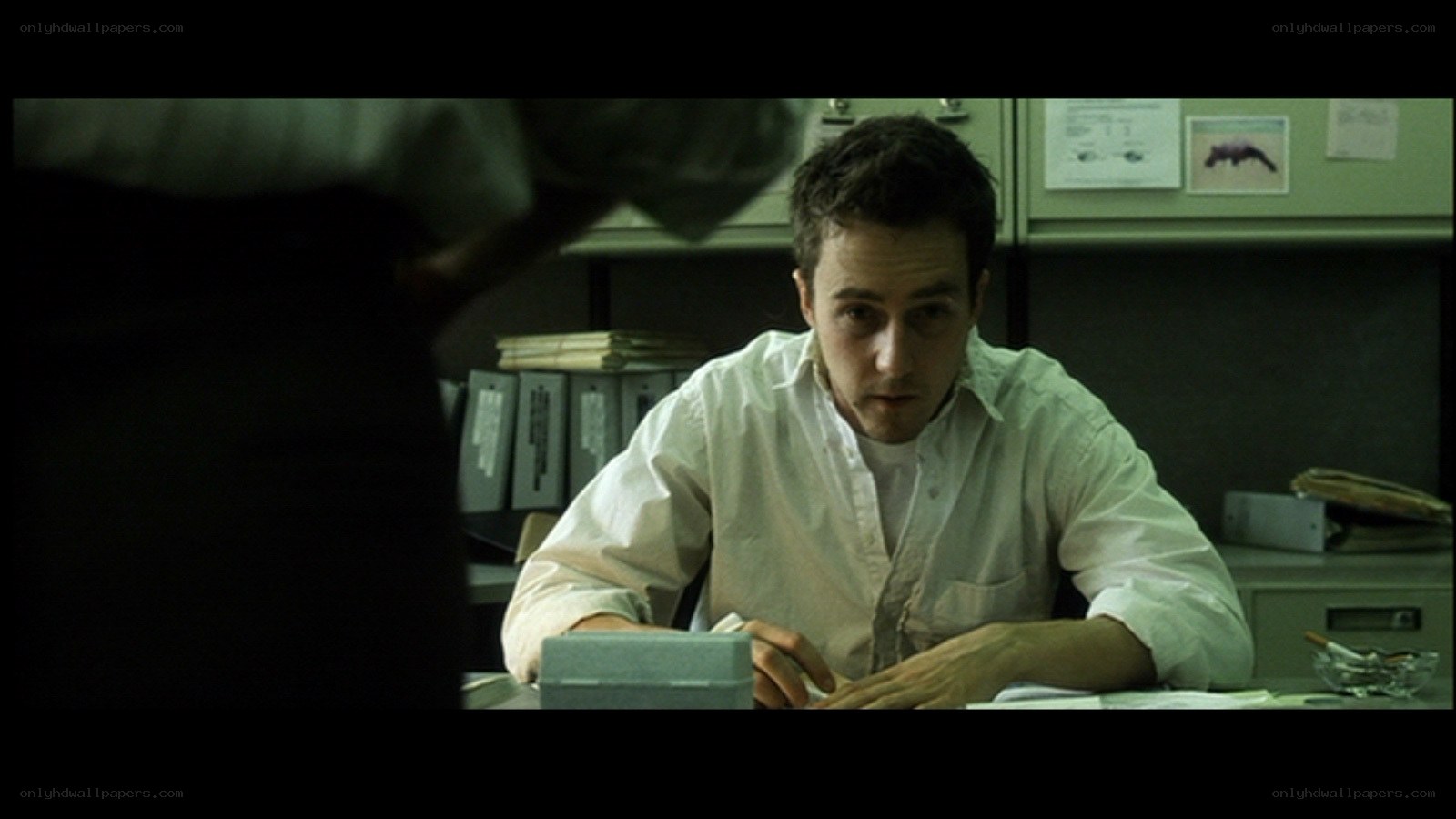 man sitting at desk in office