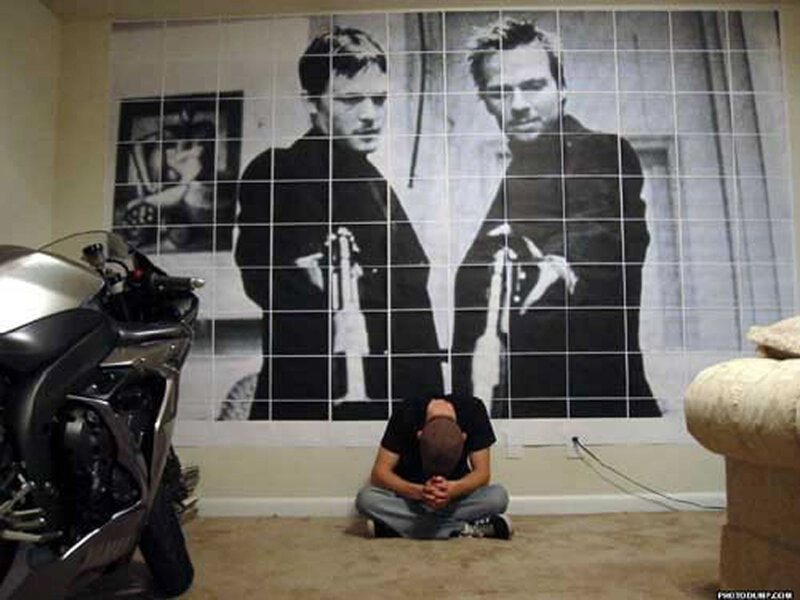 Man sitting before a mural