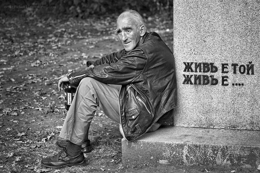 Man sitting by a monument