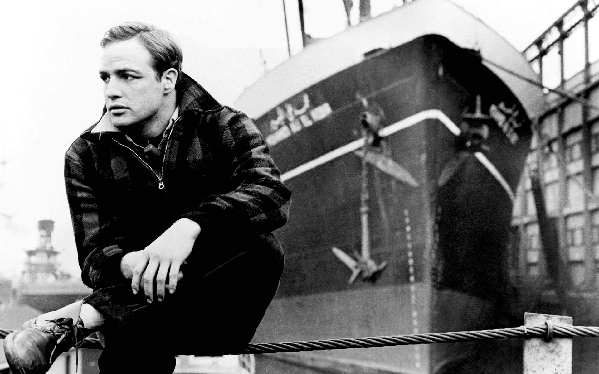 man sitting by a ship