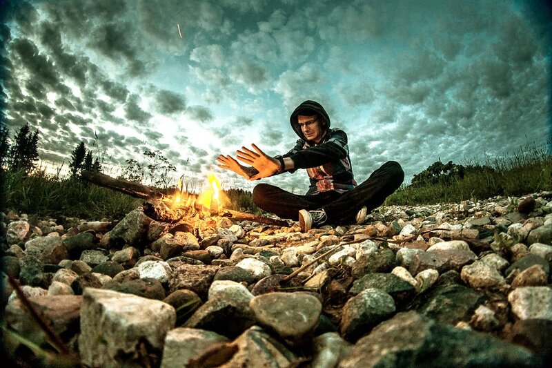 Man Sitting by Campfire