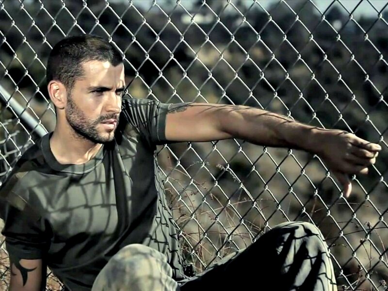 Man Sitting by Fence — Green