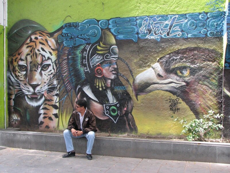 Man sitting by mural