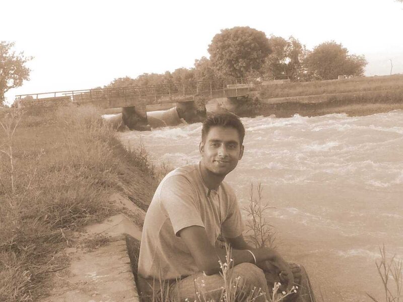 Man Sitting by River