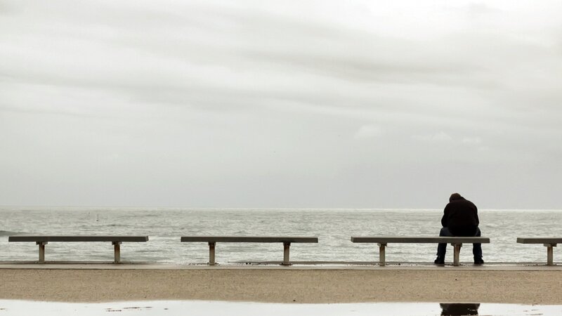 Man sitting by the sea