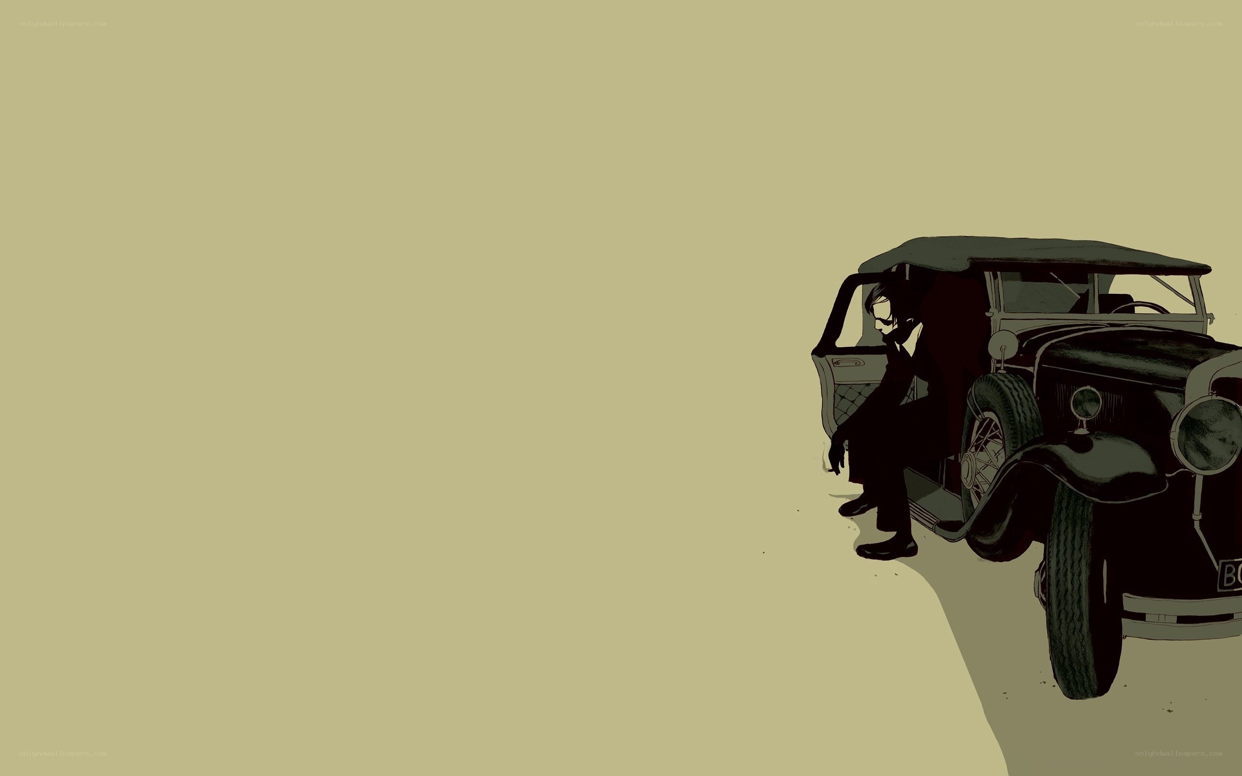 man sitting by vintage car