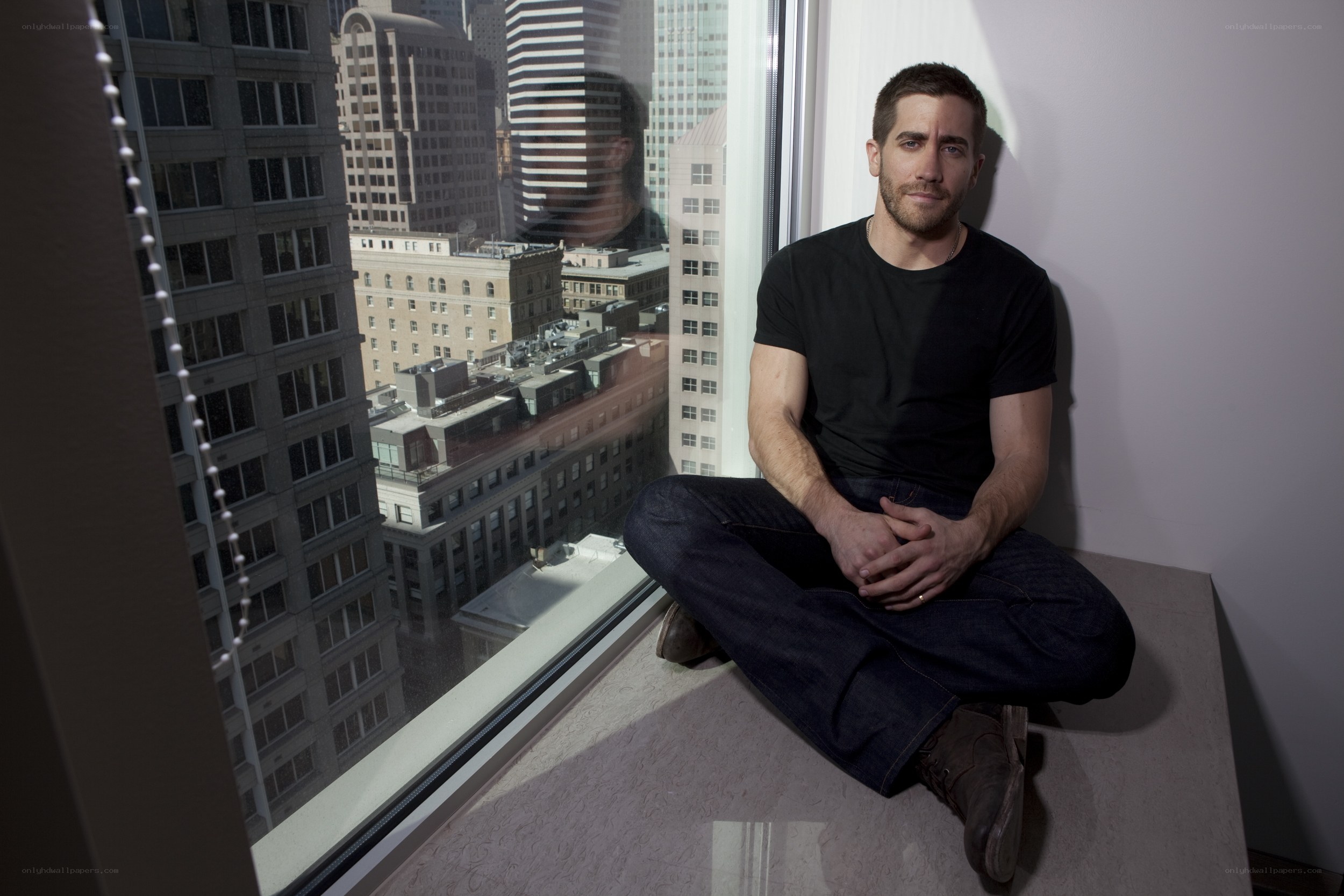 man sitting by window in city