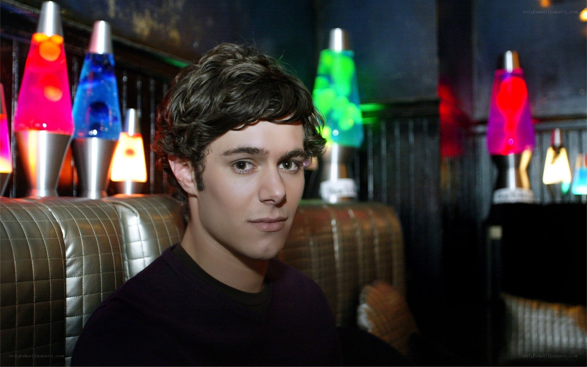 man sitting in a dimly lit room