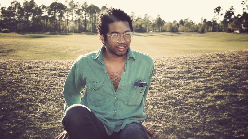 man sitting in a field