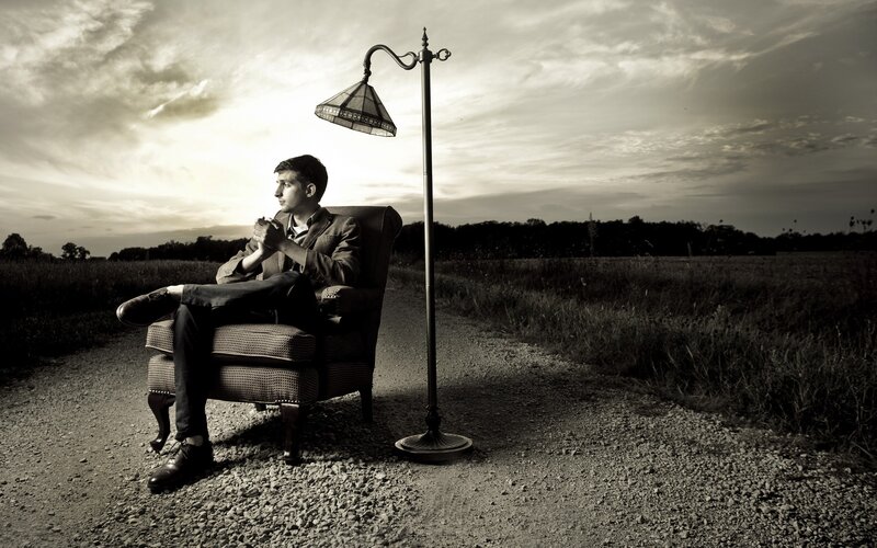 Man Sitting in Armchair — Black, Dramatic, Sunset