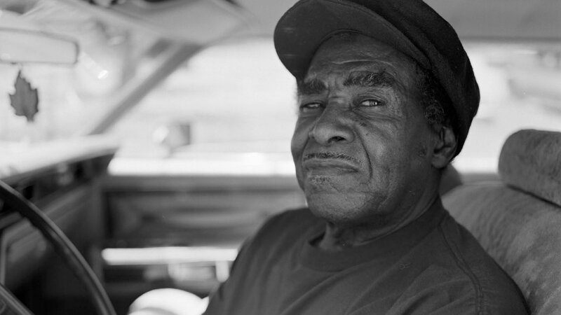 man sitting in car