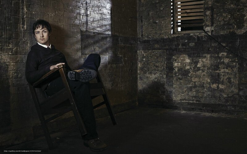 Man Sitting in Chair — Black, Dramatic, Photograph, Brick Wall