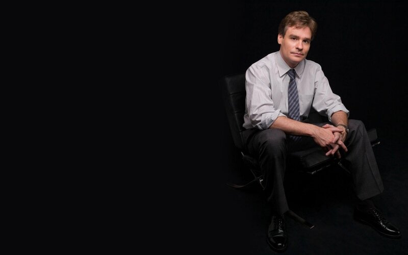 Man Sitting in Chair — Black, Serious