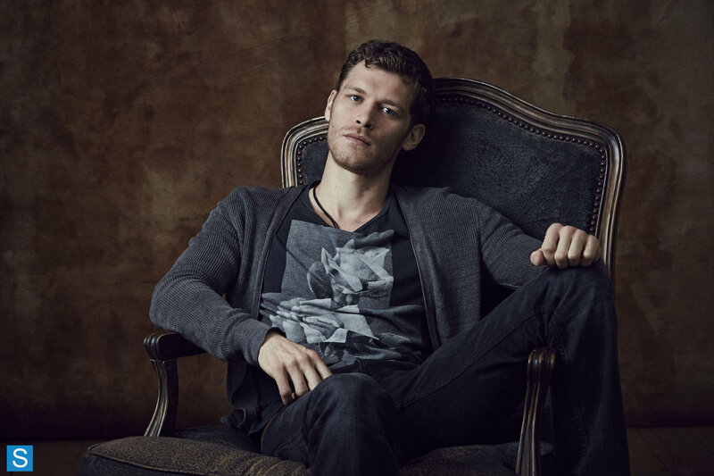Man Sitting in Chair — Brown, Serious