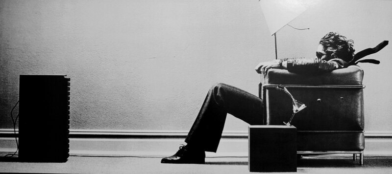 man sitting in chair with drink