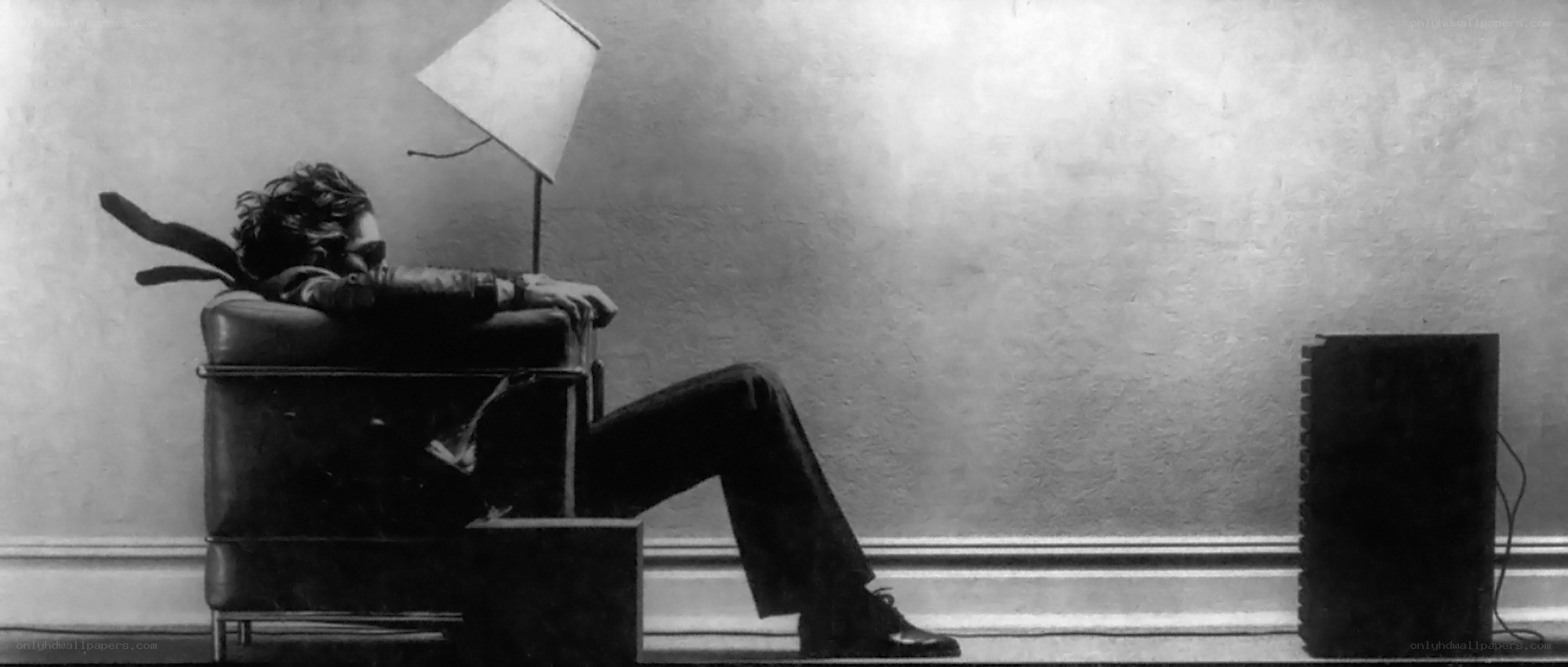 man sitting in chair with lamp